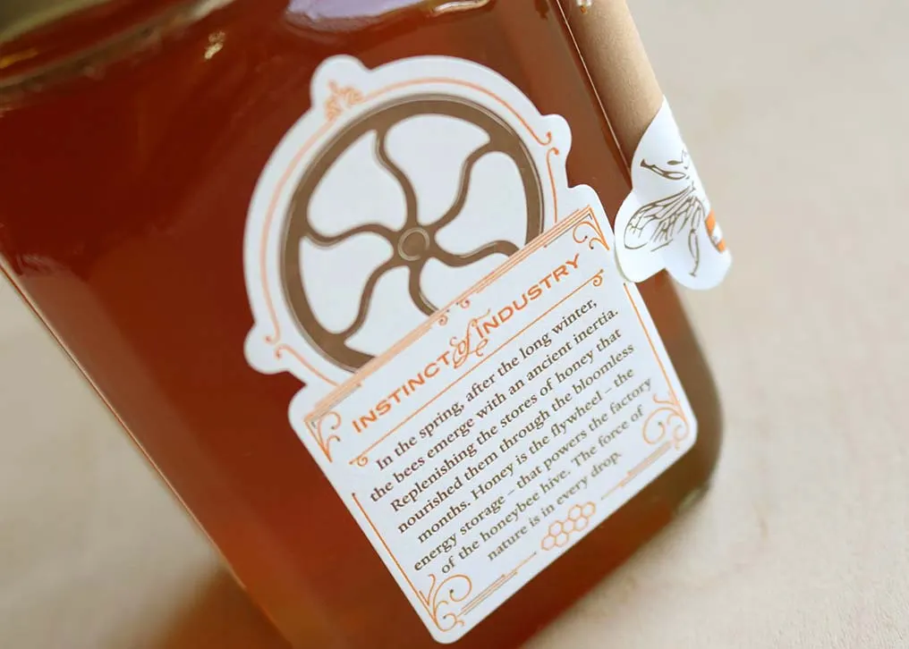 Honey jar with letterpress front label showing die-cut shape and two-color printing