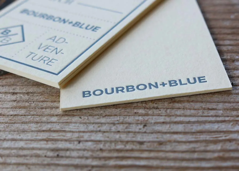 Close-up of deep letterpress impression showing front and back printing on thick cotton paper