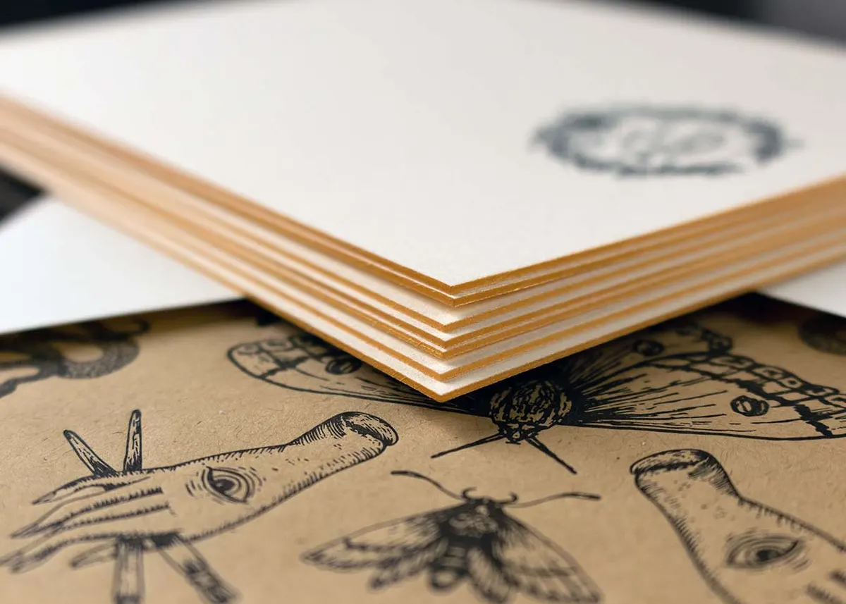 Note card and envelope displayed together showing the coordinating letterpress design on kraft liner