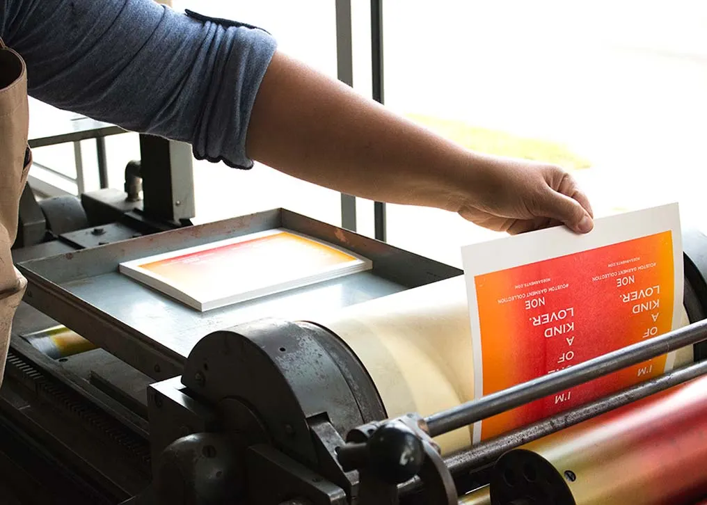 Edge view of duplexed hang tags showing text weight paper bonded to thick coasterboard