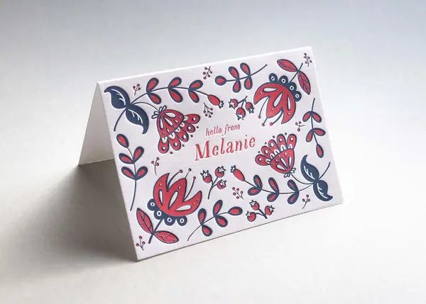 Two-color letterpress note cards with floral pattern and coordinating red envelopes