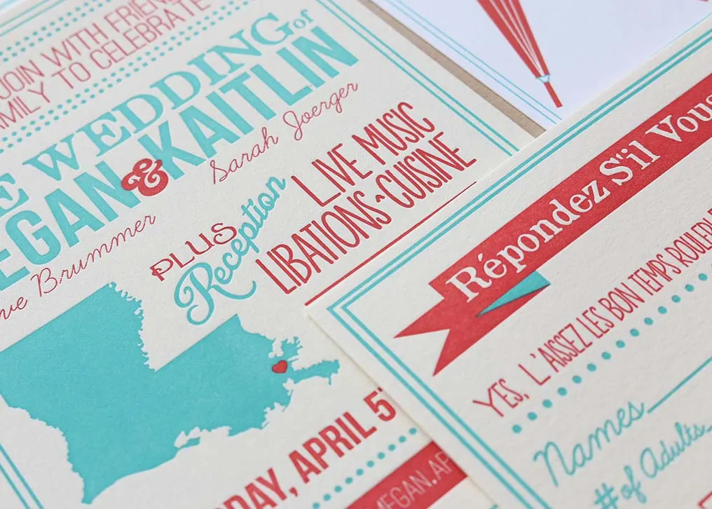 Close-up of two-color letterpress wedding invitation showing blue and red ink impression on Crane's Lettra